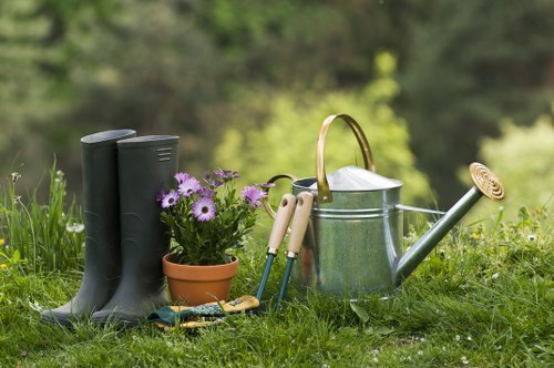 Gardener mowing a Hampstead front lawn